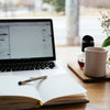 MacBook Pro near white open book