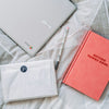 Getting Things Done book beside gray Acer Chromebook on gray textile