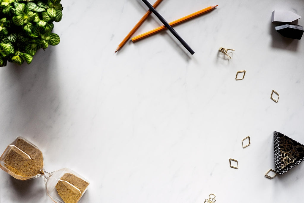 three assorted-color pencils on white surface
