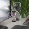 clear hour glass on white table