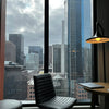 a chair and a table in a room with a view of a city
