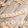scrabble tiles spelling out the word creative