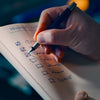 Hand checking off items on a to-do list.
