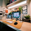 a desk with a laptop and a monitor on it