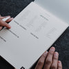 a person writing on a piece of paper