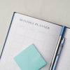 a planner with a pen on top of it