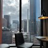 a chair and a table in a room with a view of a city