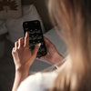 a woman holding a cell phone up to her face