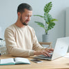 Man typing on laptop at a desk