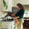 Woman cooking on a stovetop in a kitchen